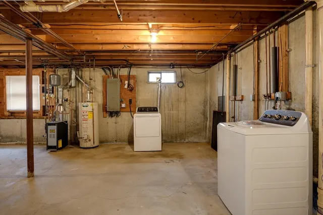 a view of storage and utility room with refrigerator and washer