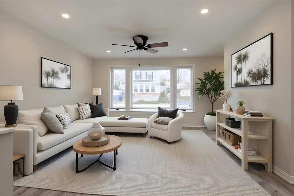 49 Douglas Avenue, Unit 49 Maynard, MA 01754 - Photo 2 of 23 a living room with furniture and a large window