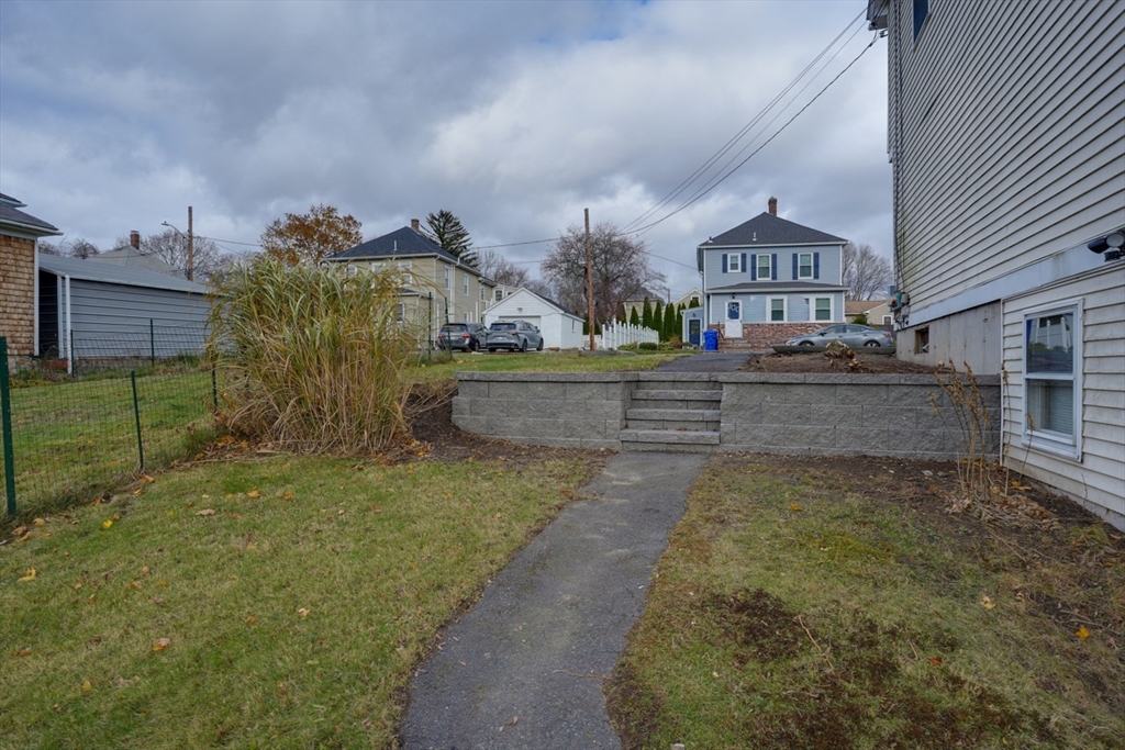 49 Douglas Avenue, Unit 49 Maynard, MA 01754 - Photo 21 of 23 a view of a house with a yard