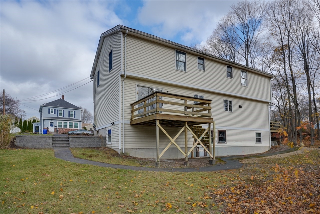 49 Douglas Avenue, Unit 49 Maynard, MA 01754 - Photo 22 of 23 a view of a white house with large windows