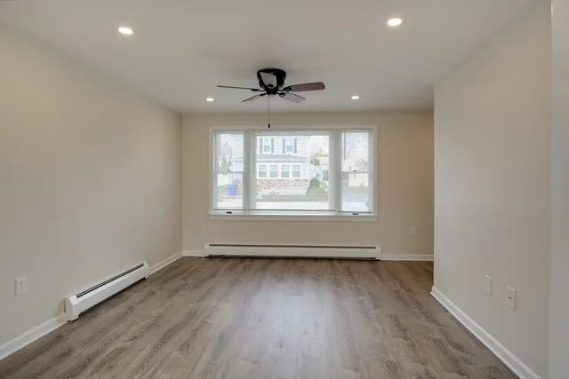 wooden floor in an empty room with a window