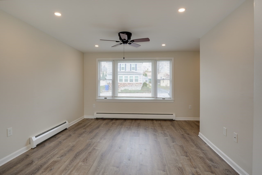 49 Douglas Avenue, Unit 49 Maynard, MA 01754 - Photo 4 of 23 wooden floor in an empty room with a window