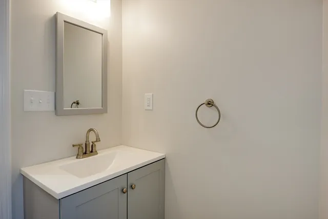 a bathroom with a sink and mirror