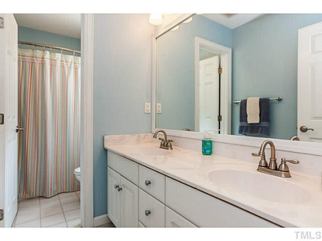 12308 Galway Drive Raleigh, NC 27613 - Photo 17 of 25 Dual vanities in the second full bath have updated faucets. Privacy door to tub & toilet.