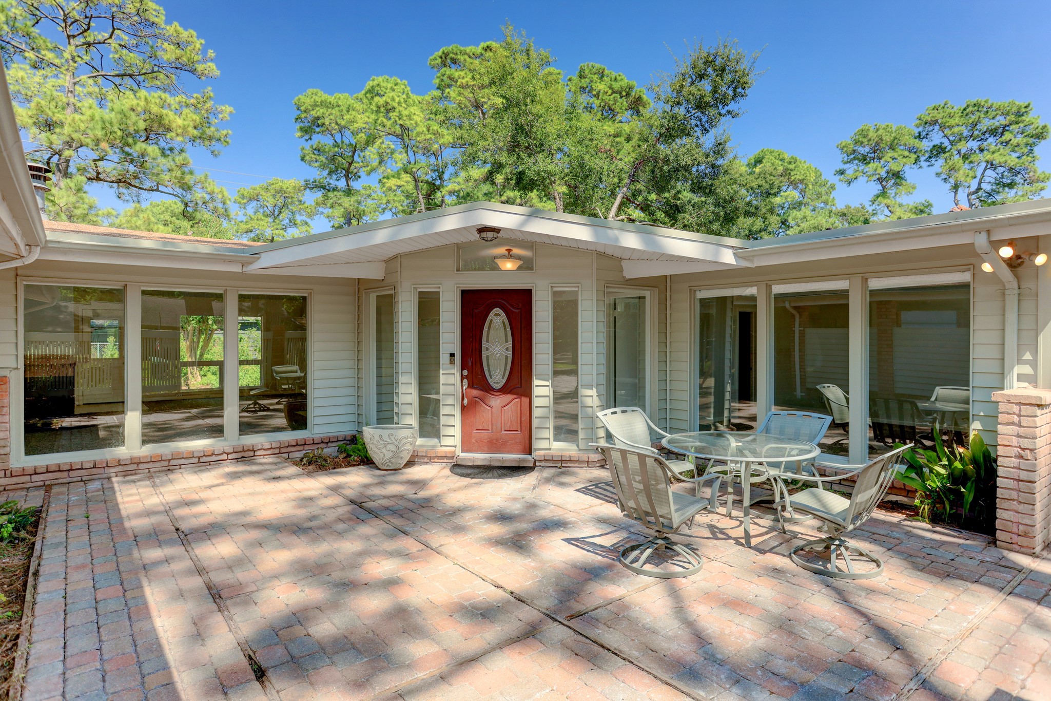 10226 Ivyridge Road Houston, TX 77043 - Photo 2 of 37 a view of a chair and table in the patio and a front view of a house