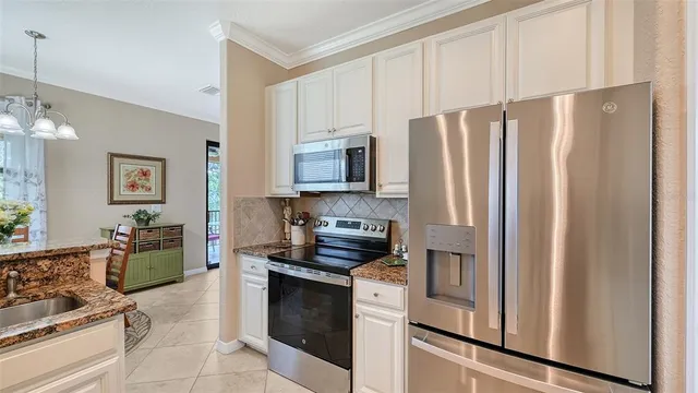 a kitchen with stainless steel appliances a refrigerator sink and stove