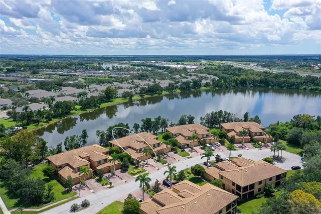 an aerial view of a house with a lake view