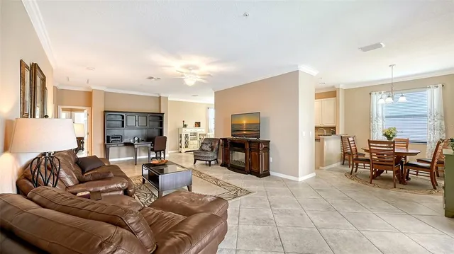 a living room with furniture a large window and a flat screen tv