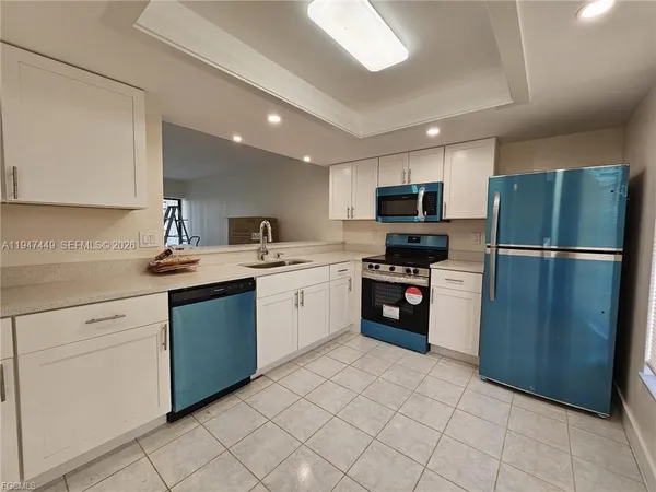 a kitchen with a sink and steel appliances