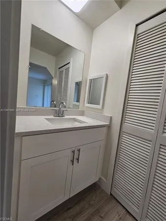 a bathroom with a shower sink and mirror
