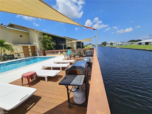 a view of a rooftop deck with couch and chairs