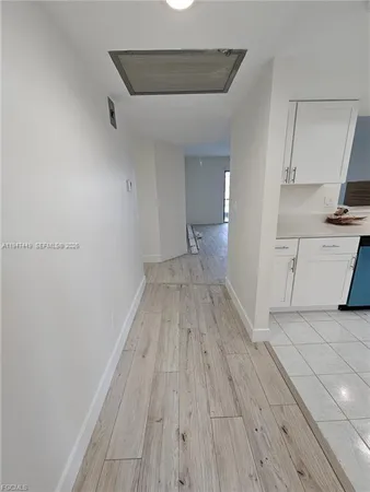 a view of a kitchen with wooden floor and a sink