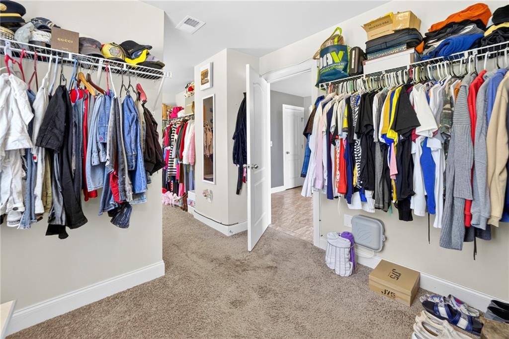 2300 Tucker Mill Road Southwest Conyers, GA 30094 - Photo 24 of 45 a view of walk in closet with clothes