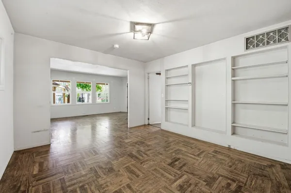 a view of an empty room and a window