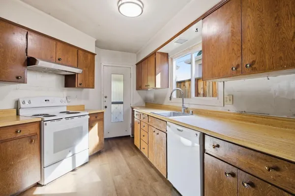 a kitchen with stainless steel appliances granite countertop a sink stove and cabinets