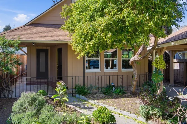 a front view of a house with garden