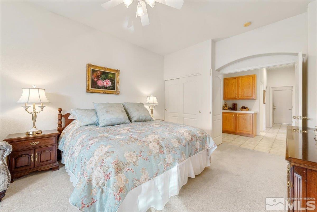 10055 Kentfield Place Reno, NV 89521 - Photo 18 of 39 a bedroom with a bed and a walk in closet