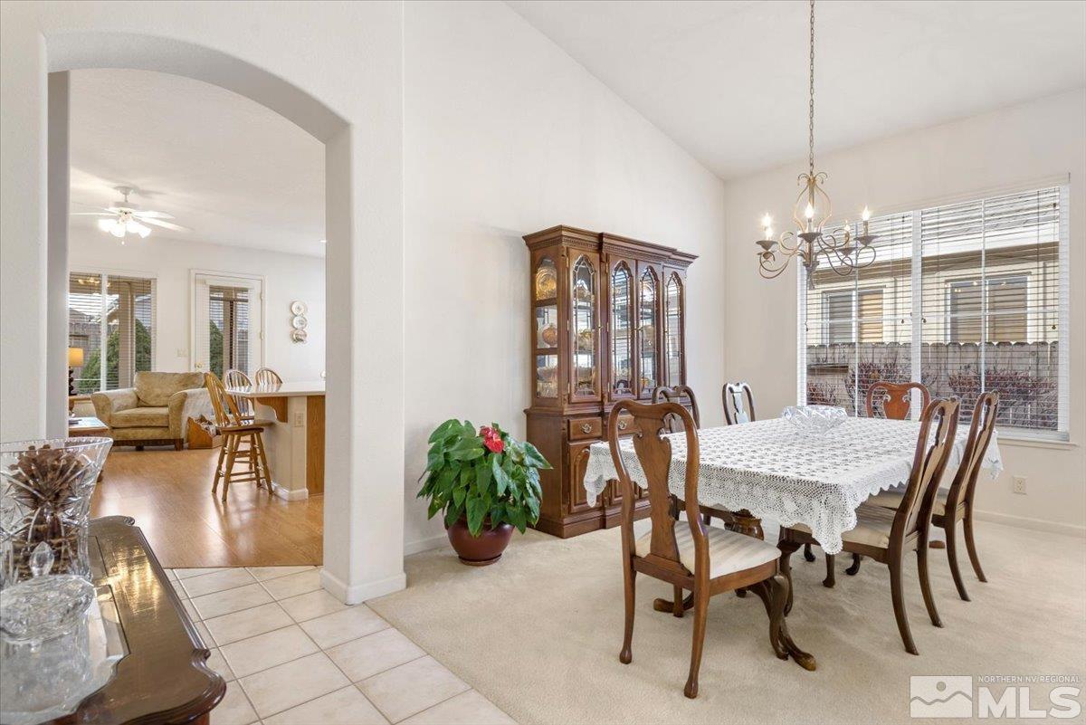 10055 Kentfield Place Reno, NV 89521 - Photo 6 of 39 a view of a dining room with furniture and chandelier