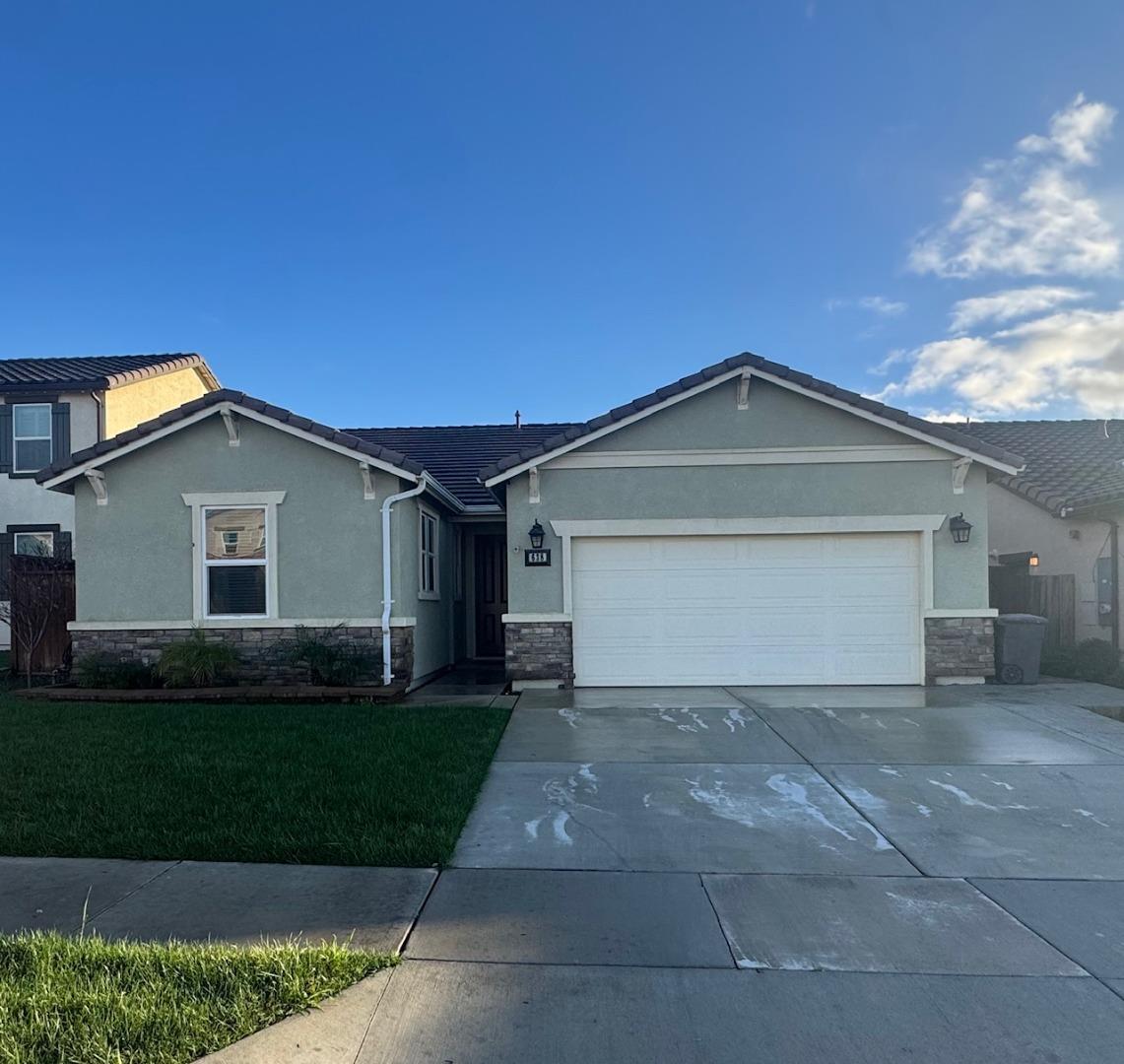 638 Robledo Drive Soledad, CA 93960 - Photo 1 of 7 a front view of a house with a yard and garage