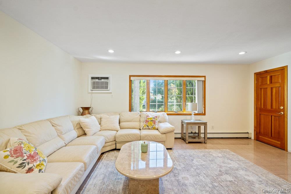 91 15th Avenue West Babylon, NY 11704 - Photo 13 of 33 a living room with furniture and a large window