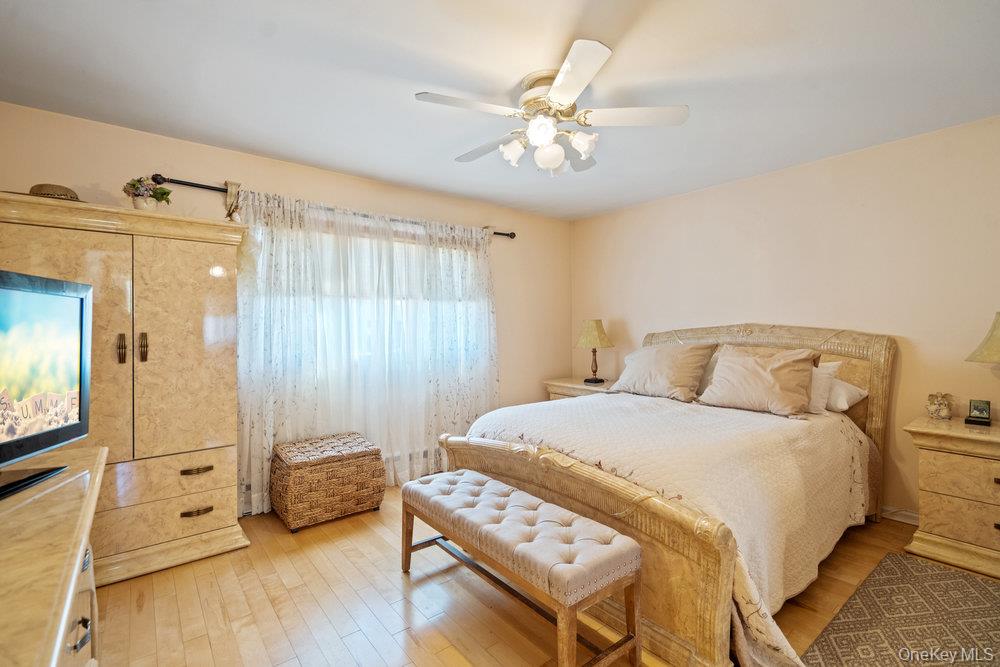 91 15th Avenue West Babylon, NY 11704 - Photo 14 of 33 a bedroom with a bed and wooden floor