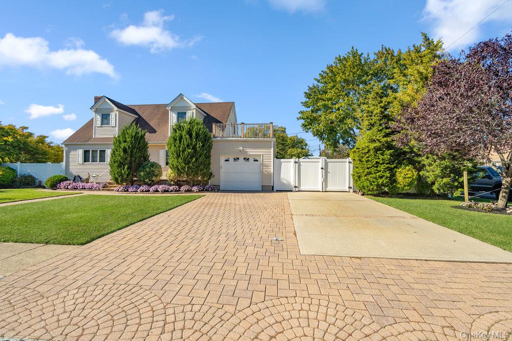 91 15th Avenue West Babylon, NY 11704 - Photo 2 of 33 a front view of a house with a yard and garage