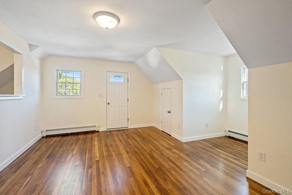91 15th Avenue West Babylon, NY 11704 - Photo 22 of 33 an empty room with wooden floor and windows