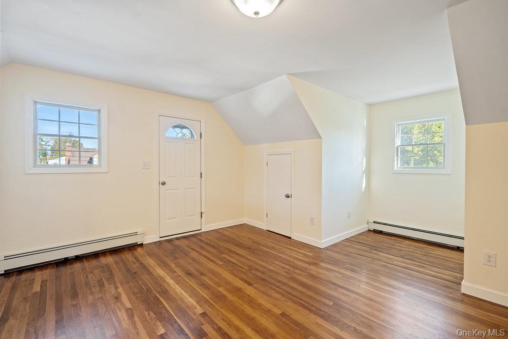 91 15th Avenue West Babylon, NY 11704 - Photo 23 of 33 an empty room with wooden floor and windows
