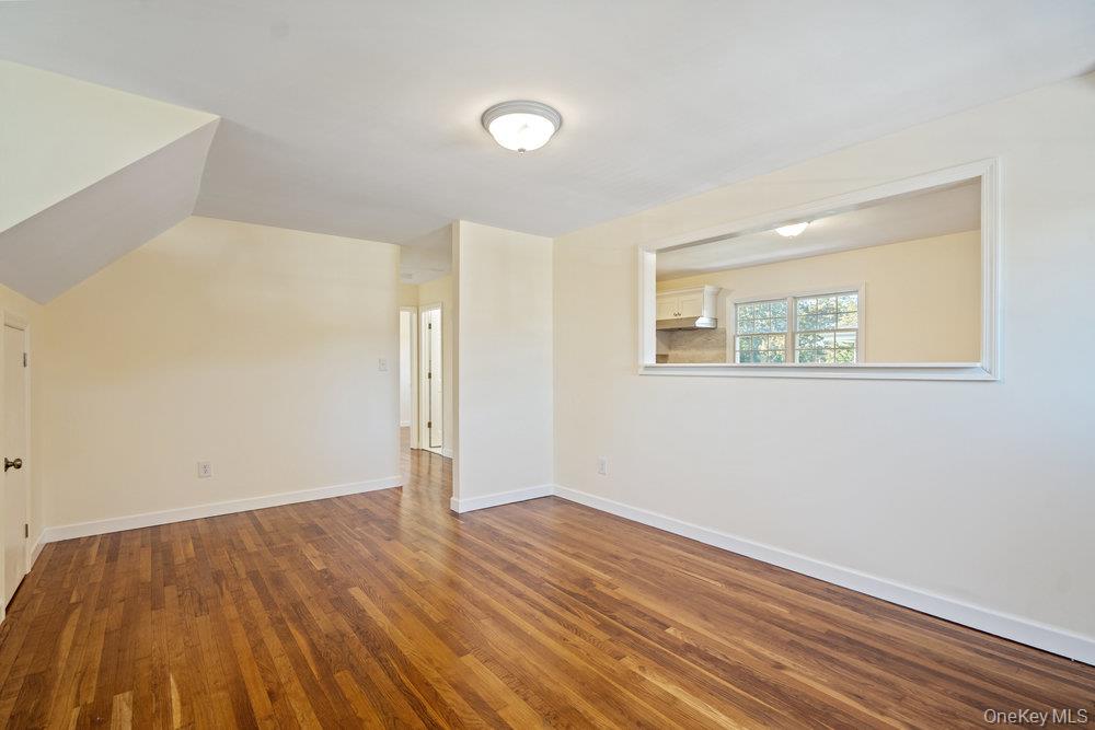 91 15th Avenue West Babylon, NY 11704 - Photo 24 of 33 an empty room with wooden floor and windows
