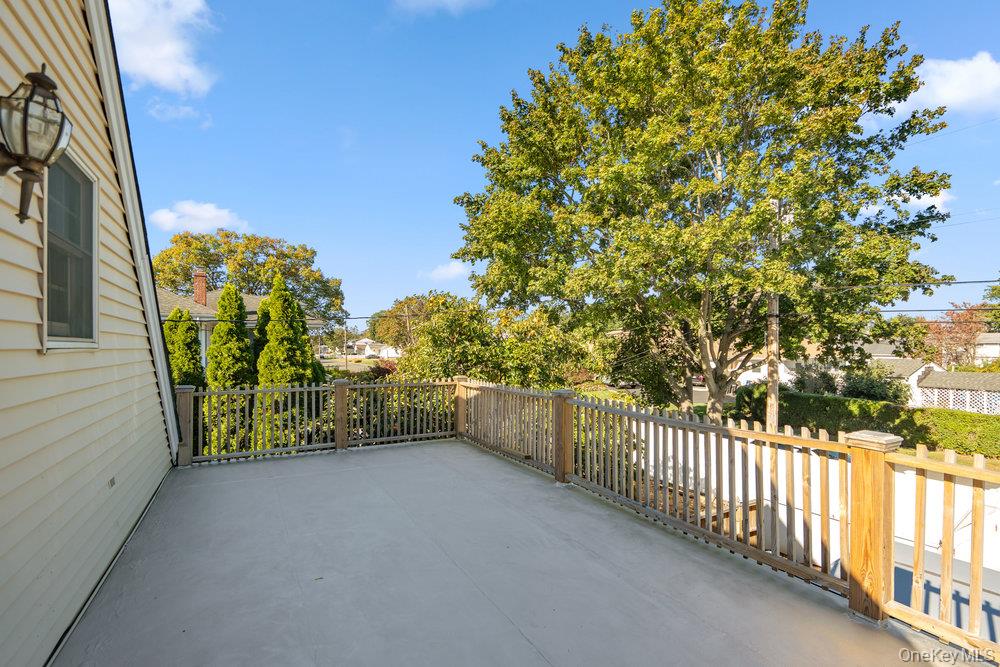 91 15th Avenue West Babylon, NY 11704 - Photo 26 of 33 a view of a balcony with trees