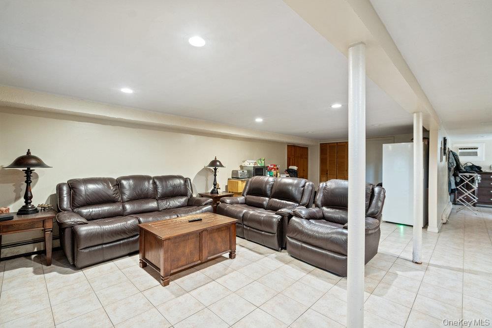 91 15th Avenue West Babylon, NY 11704 - Photo 27 of 33 a living room with furniture and a glass door