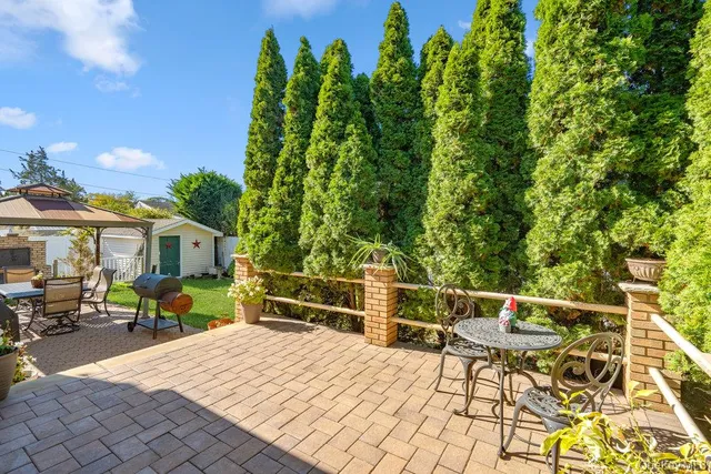 a roof deck with table and chairs under an umbrella
