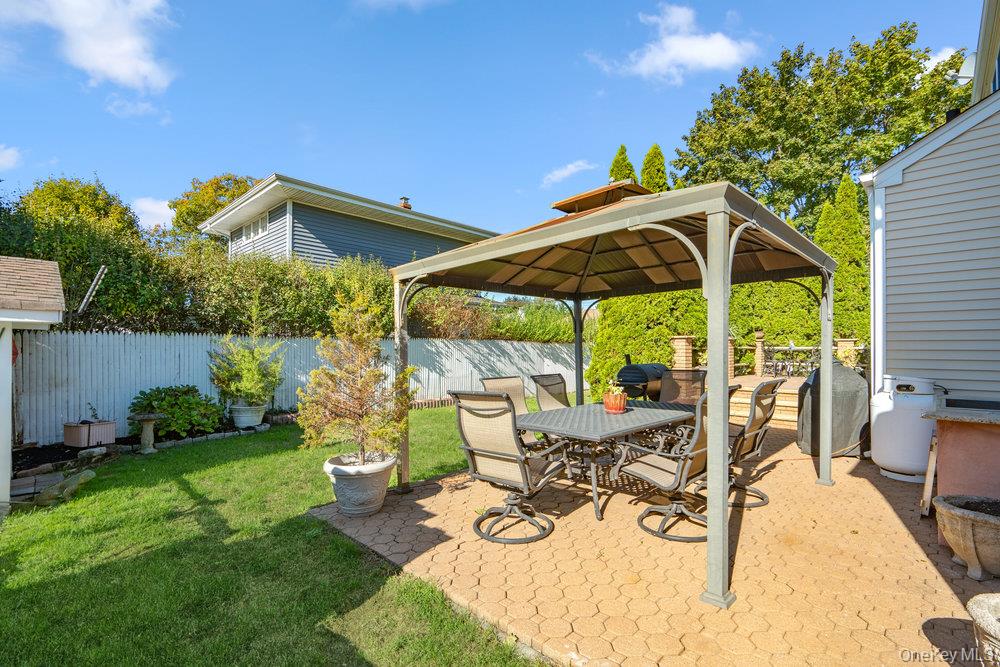 91 15th Avenue West Babylon, NY 11704 - Photo 31 of 33 a view of a backyard with sitting area