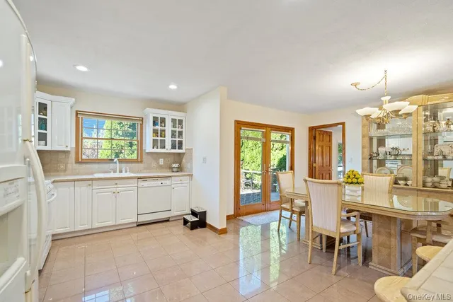 a room with kitchen island granite countertop furniture and a large window