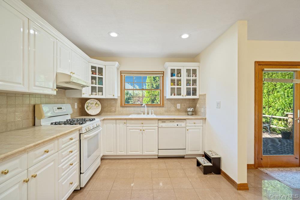 91 15th Avenue West Babylon, NY 11704 - Photo 5 of 33 a kitchen with a sink stove and cabinets