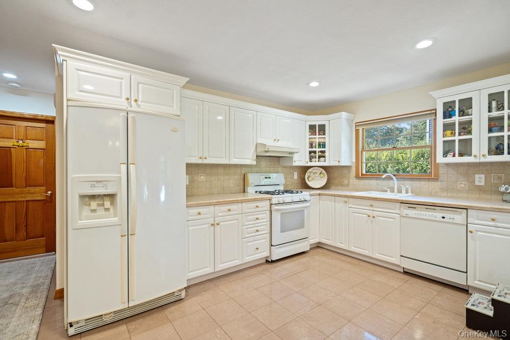 91 15th Avenue West Babylon, NY 11704 - Photo 6 of 33 a kitchen with white cabinets and white appliances