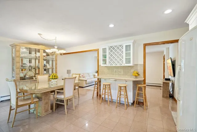 a dining hall with stainless steel appliances a dining table and chairs