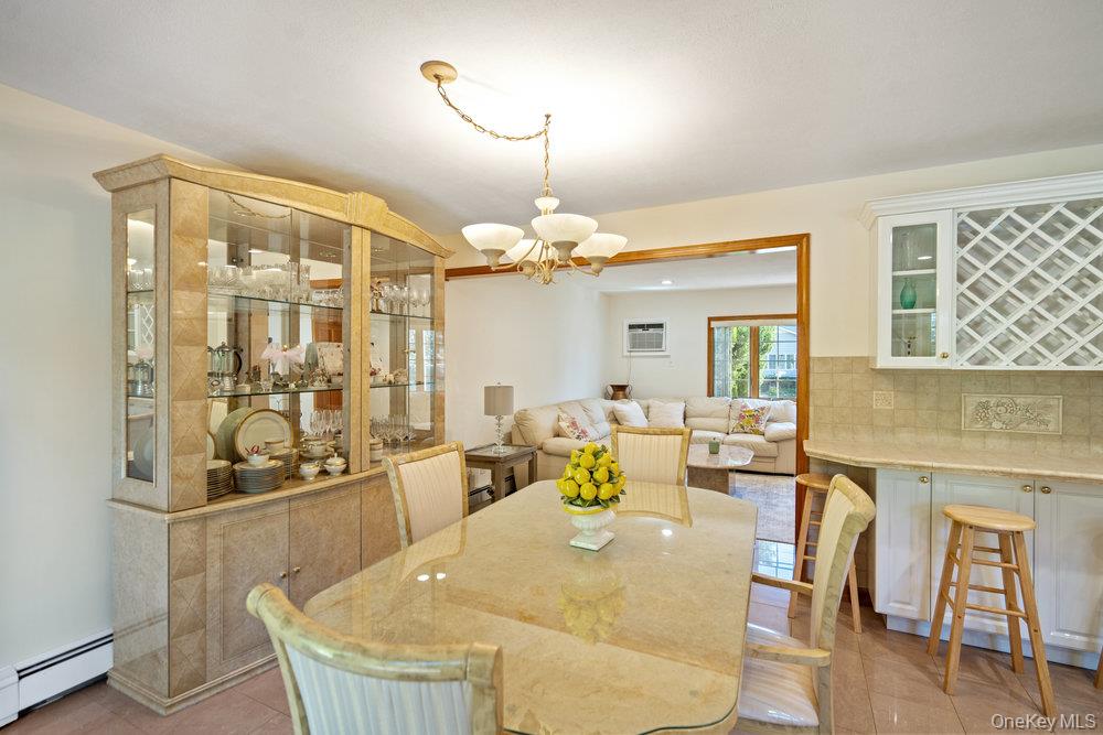 91 15th Avenue West Babylon, NY 11704 - Photo 9 of 33 a dining room with furniture and wooden floor