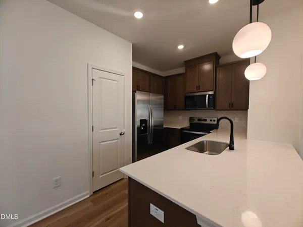a kitchen with a refrigerator and a sink