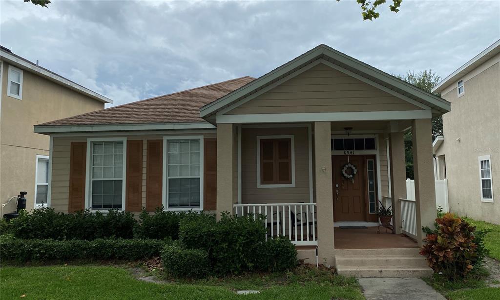 6941 Beargrass Road Harmony, FL 34773 - Photo 1 of 1 a front view of a house with garden