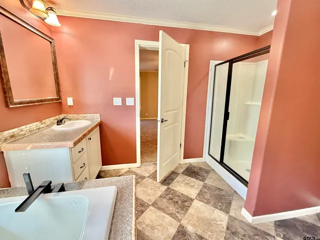 a spacious bathroom with a double vanity sink and a mirror