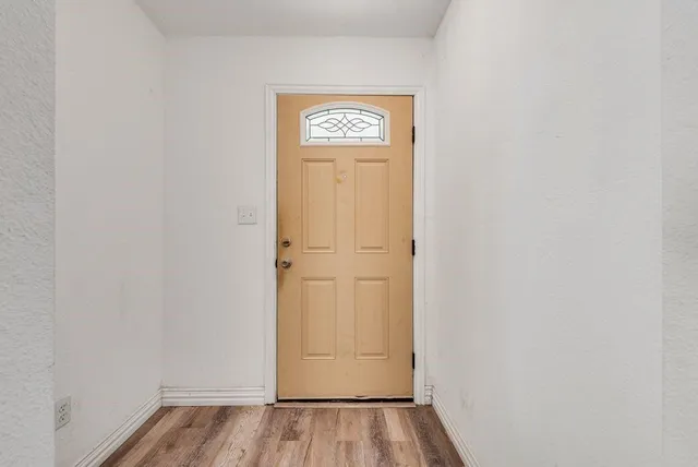 a view of front door with wooden floor