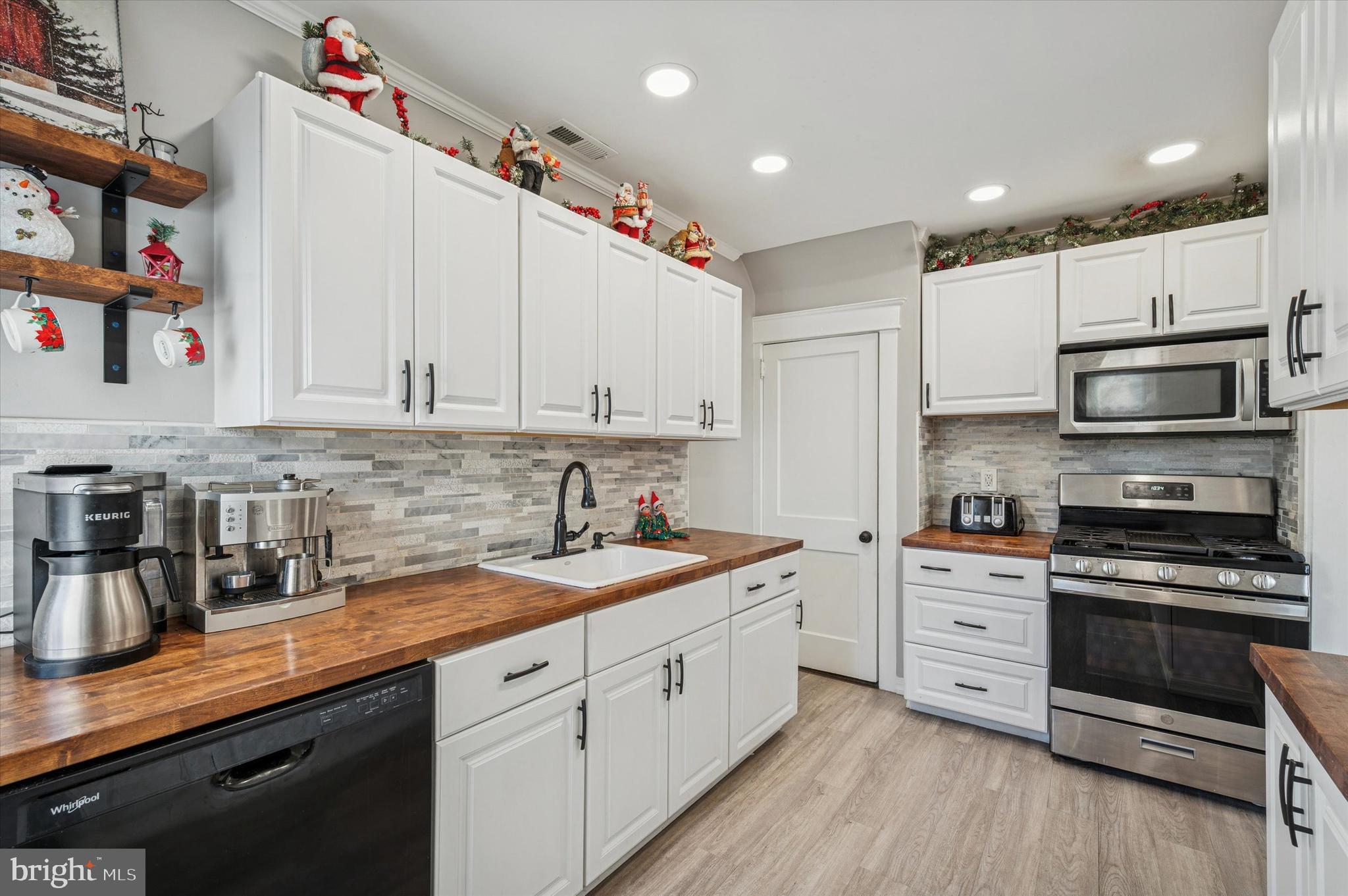 220 Sedgewood Road Springfield, PA 19064 - Photo 14 of 27 a kitchen with stainless steel appliances granite countertop a sink and cabinets
