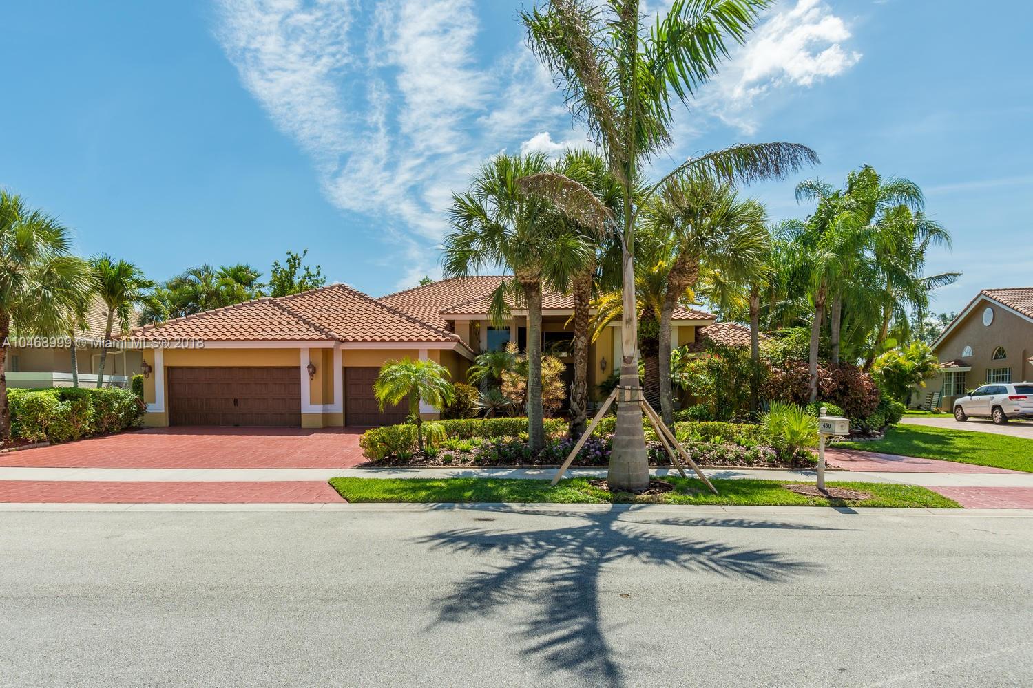 450 Alexandra Circle Weston, FL 33326 - Photo 1 of 84 front view of house with a yard and palm trees