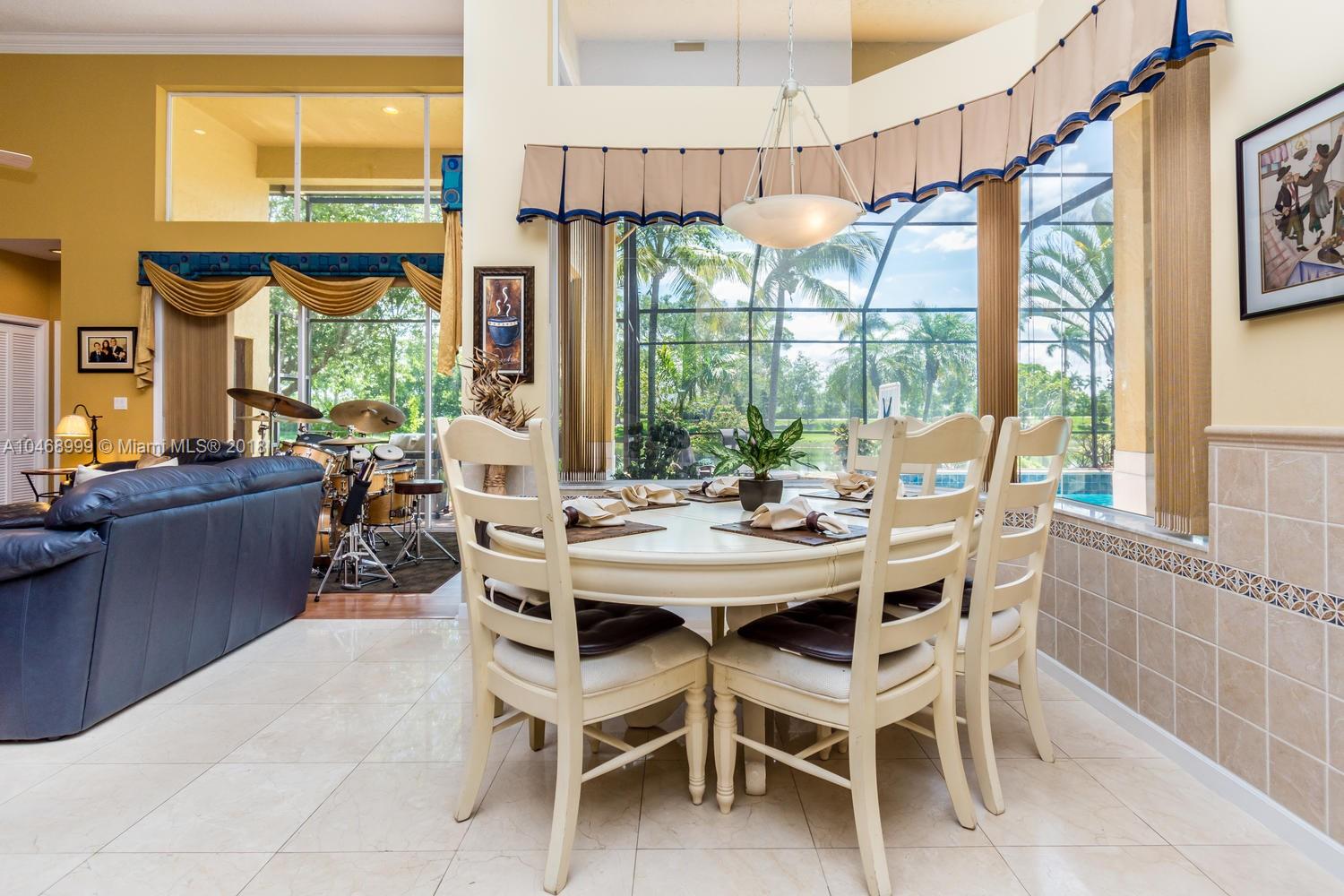 450 Alexandra Circle Weston, FL 33326 - Photo 30 of 84 a view of a dining room with furniture large windows and wooden floor