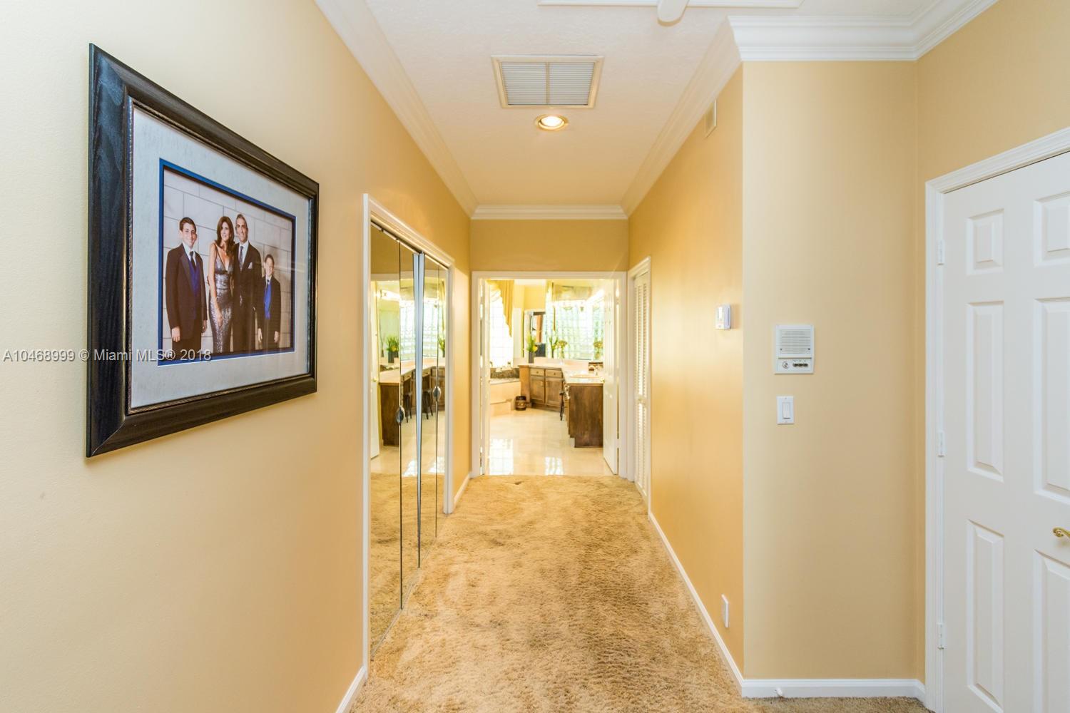 450 Alexandra Circle Weston, FL 33326 - Photo 43 of 84 a view of a hallway with paintings on the wall