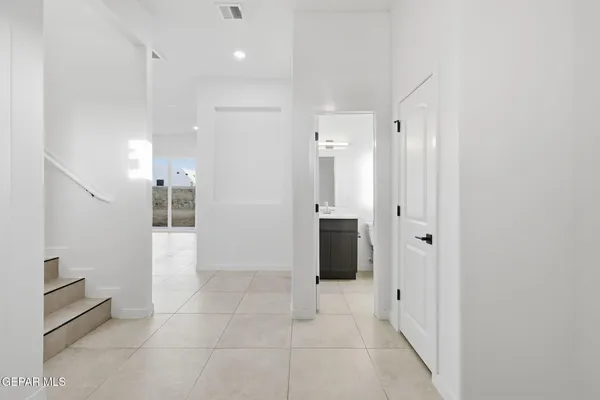 a bathroom with a glass shower door and a sink