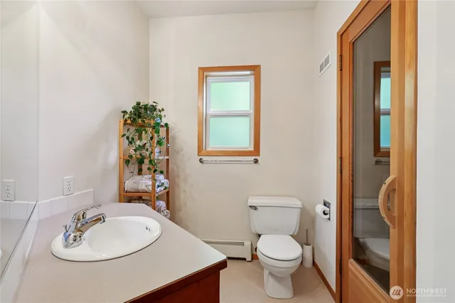 a bathroom with a toilet sink and mirror