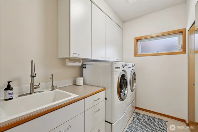 a utility room with sink dryer and washer
