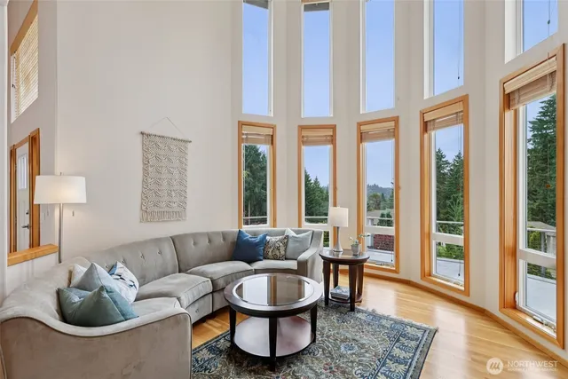 a living room with furniture and a floor to ceiling window
